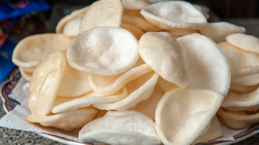 Close-up of prawn crackers on a plate with paper towel underneath to soak up oil