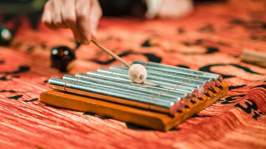 8 Note Indonesian Aura Meditation Chime being played on traditional batik fabric