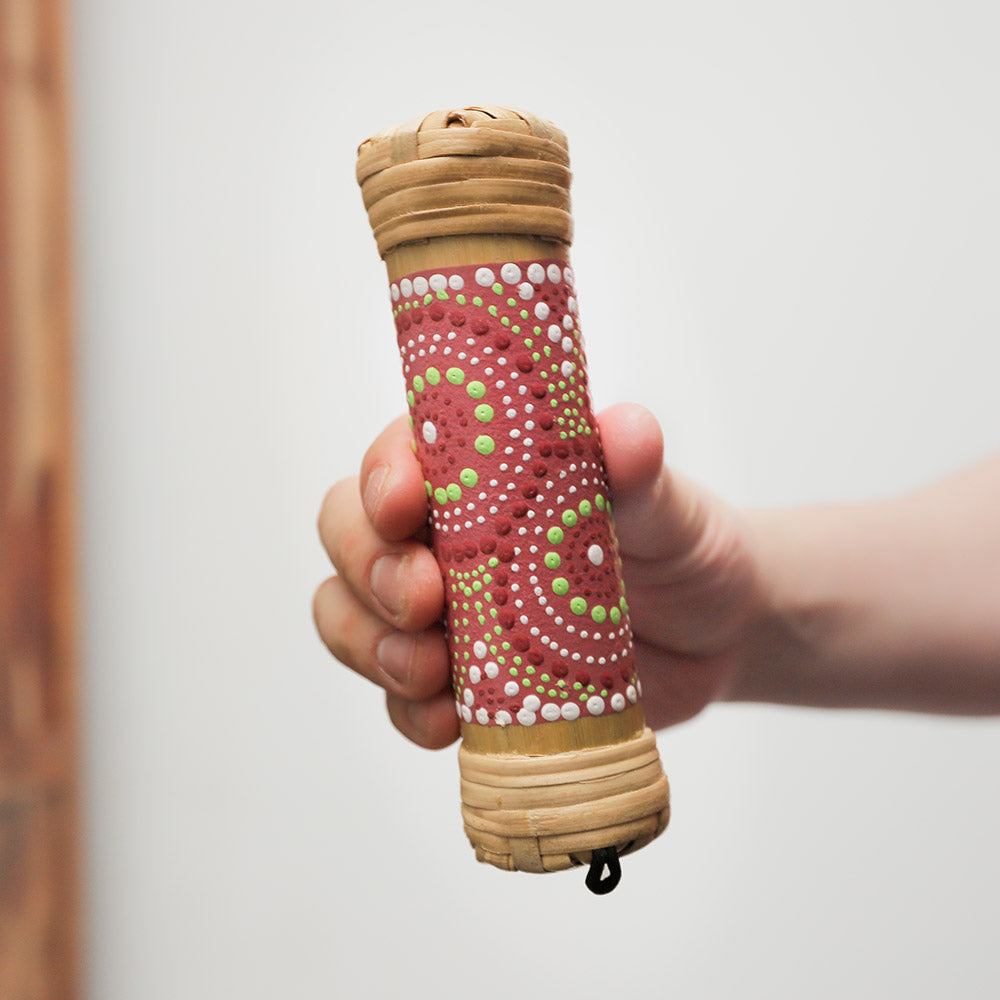 15cm bamboo rainstick with a vibrant dot-painted design, handheld percussion instrument