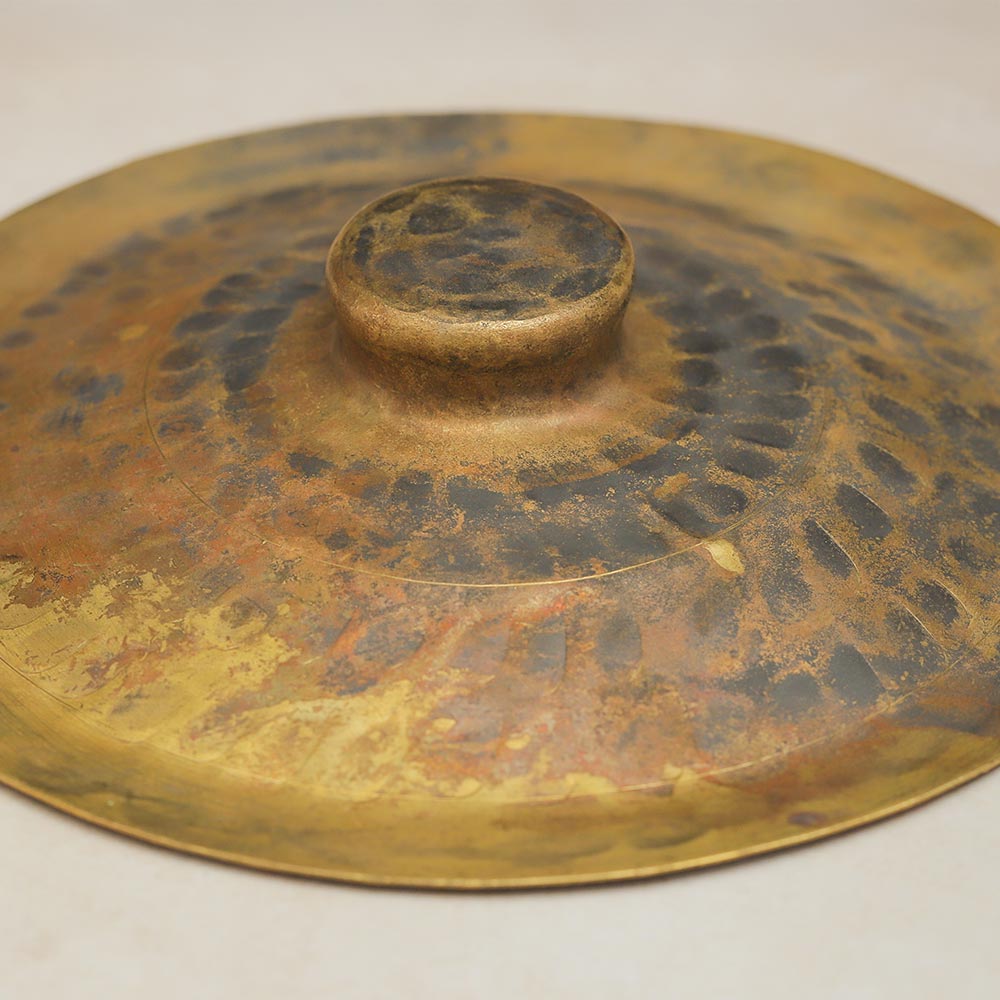 Brass hand cymbal close up, showing its details.