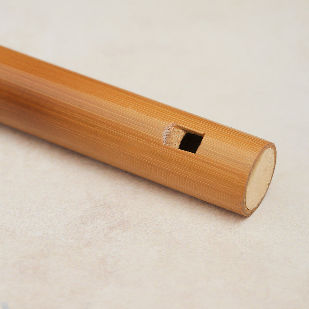 Close-up view of the back of the mouthpiece hole on a Chinese bamboo flute.