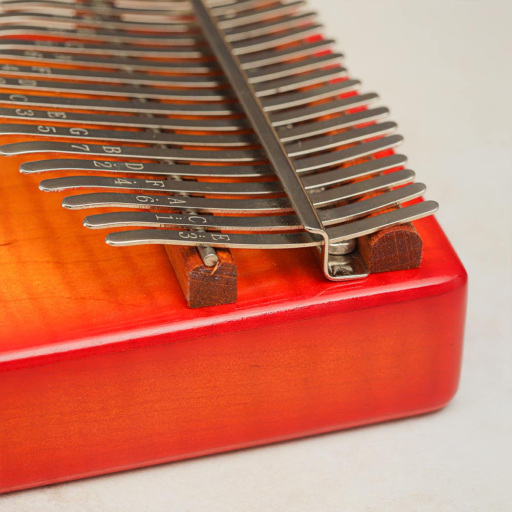 Close-up of the metal key tines on the Gecko Kalimba Sunburst Design, showing the letter and number notes clearly.