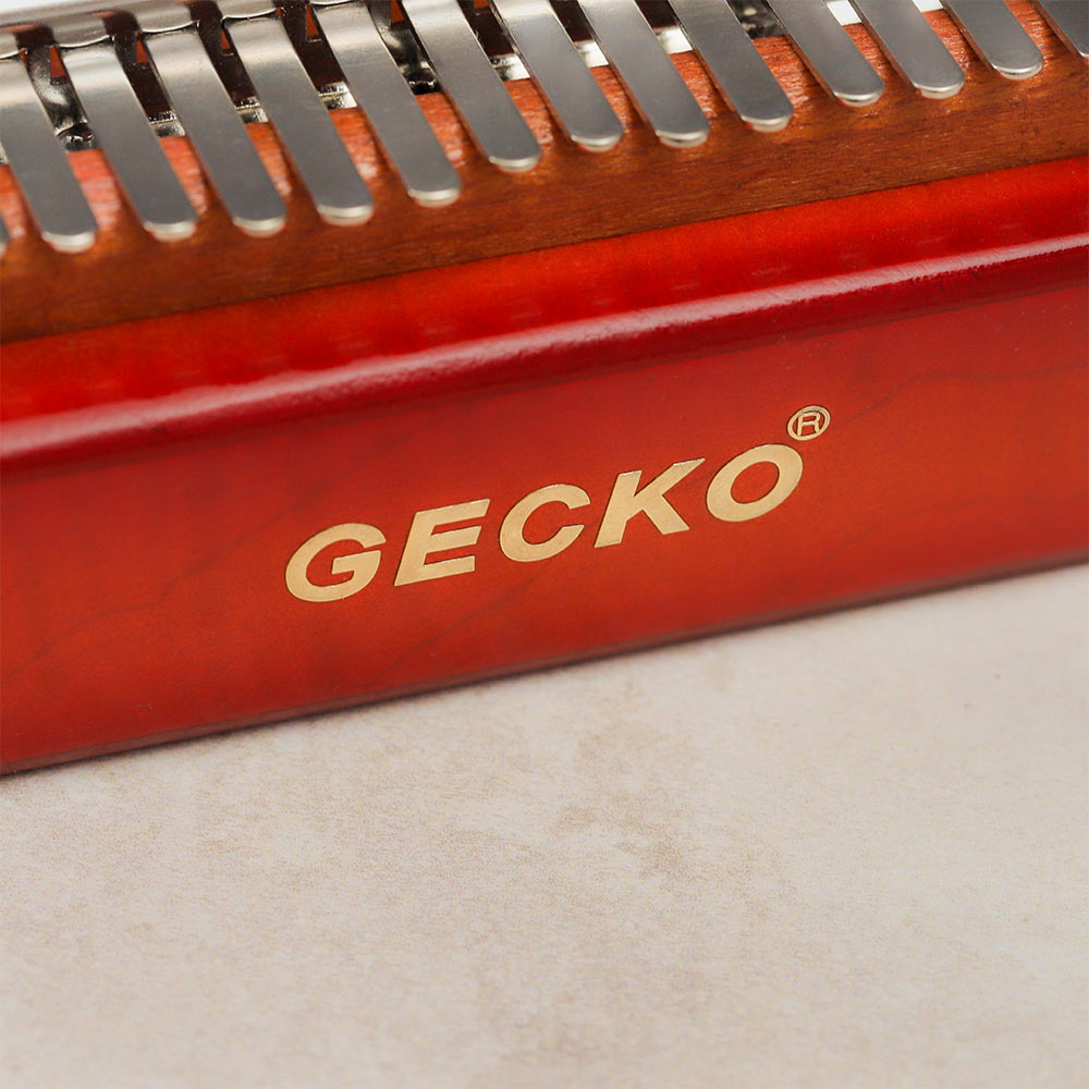 Close-up of the trademarked 'Gecko' logo on the Gecko Kalimba Sunburst Design, highlighting the brand.