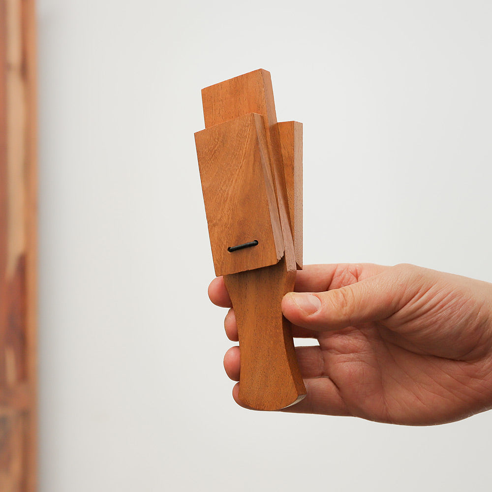 Kaita clapper, a rectangular handheld percussion instrument made from Indian mango wood.
