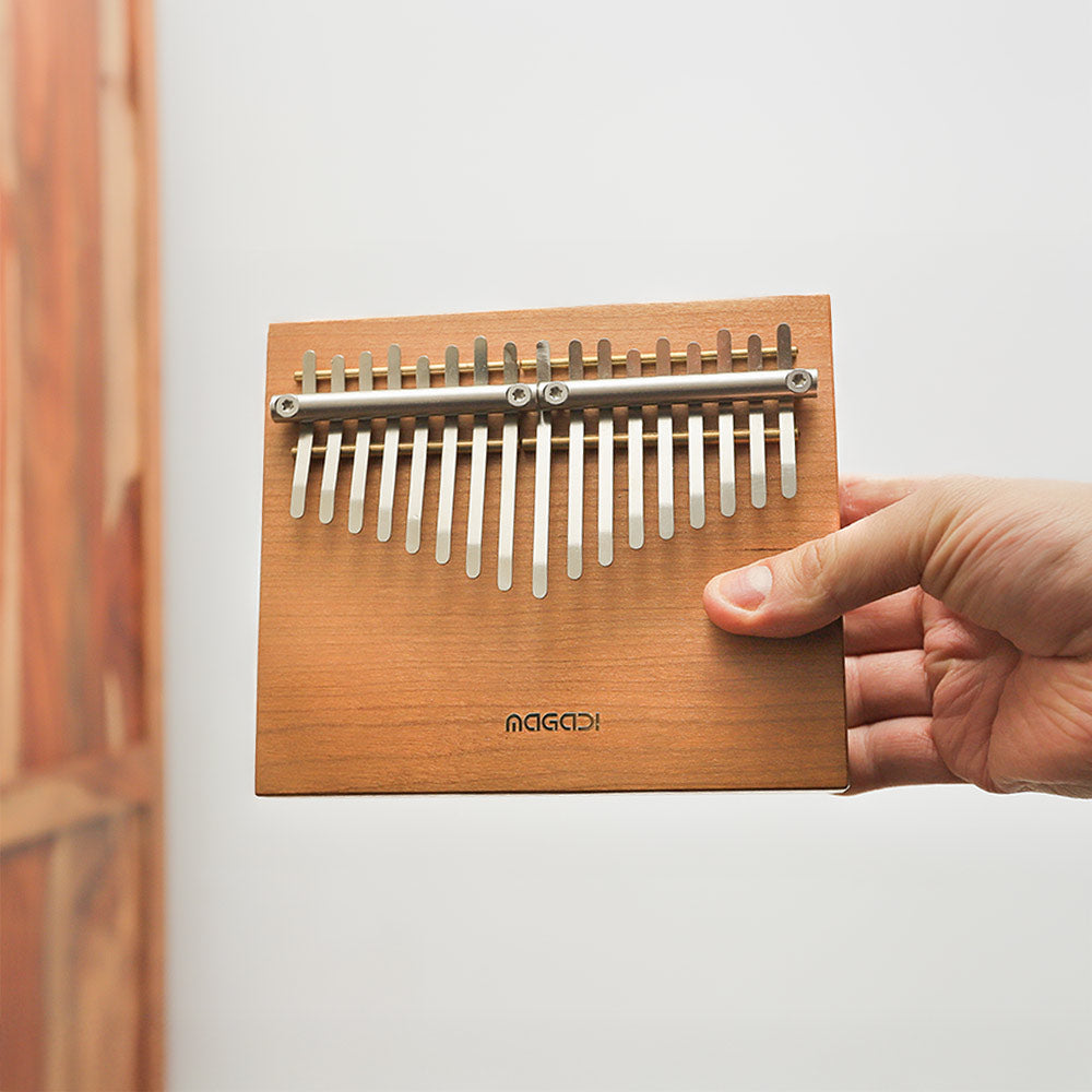 Close-up of the Magadi 17-note kalimba, a wooden thumb piano with metal tines.