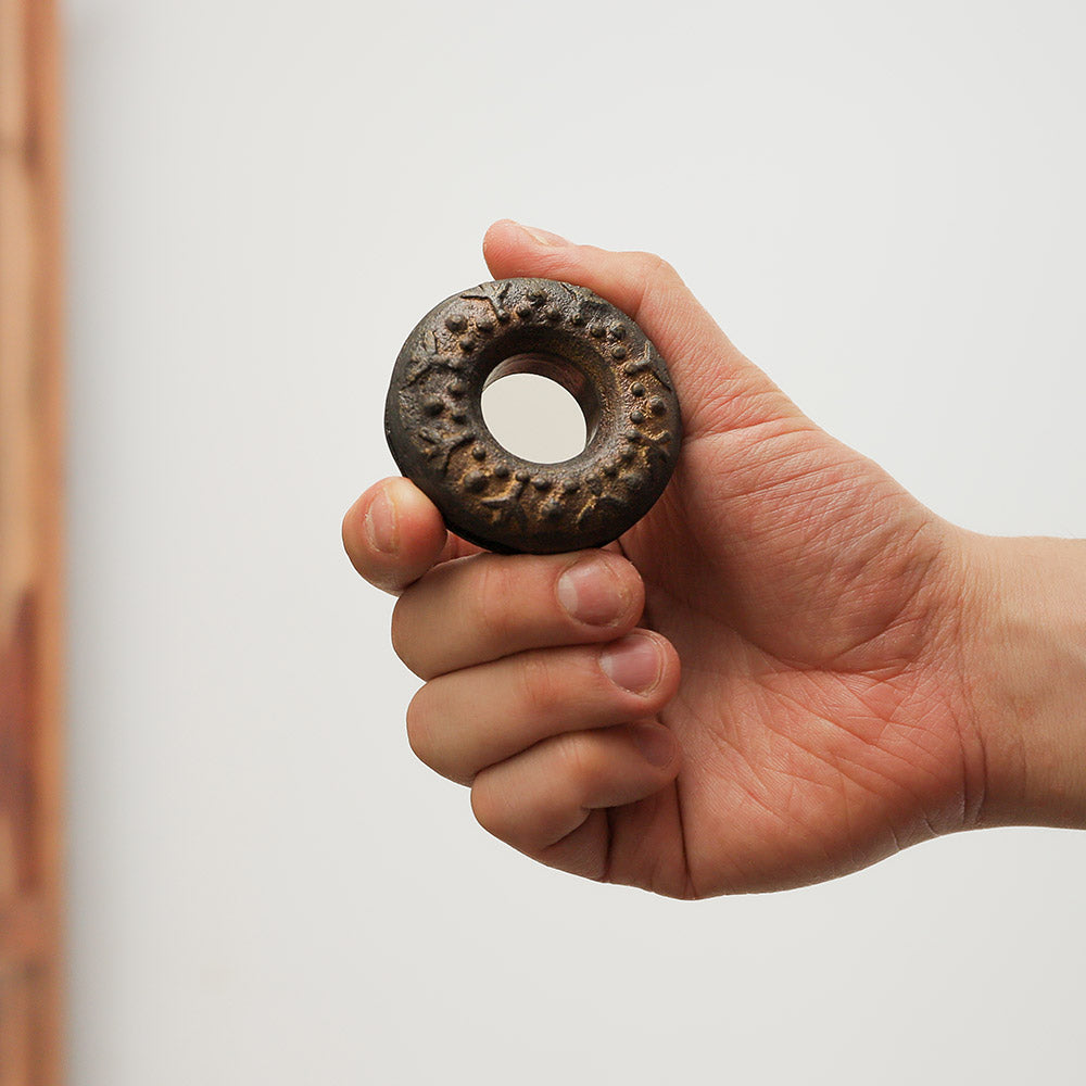 Meo finger bell, metal percussion instrument held in hand for scale