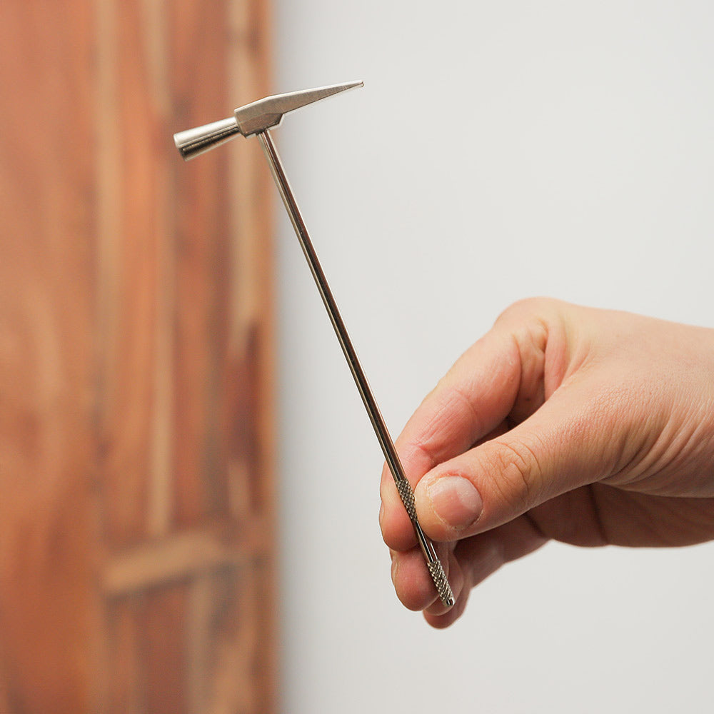 Meo finger bell, metal percussion instrument held in hand for scale