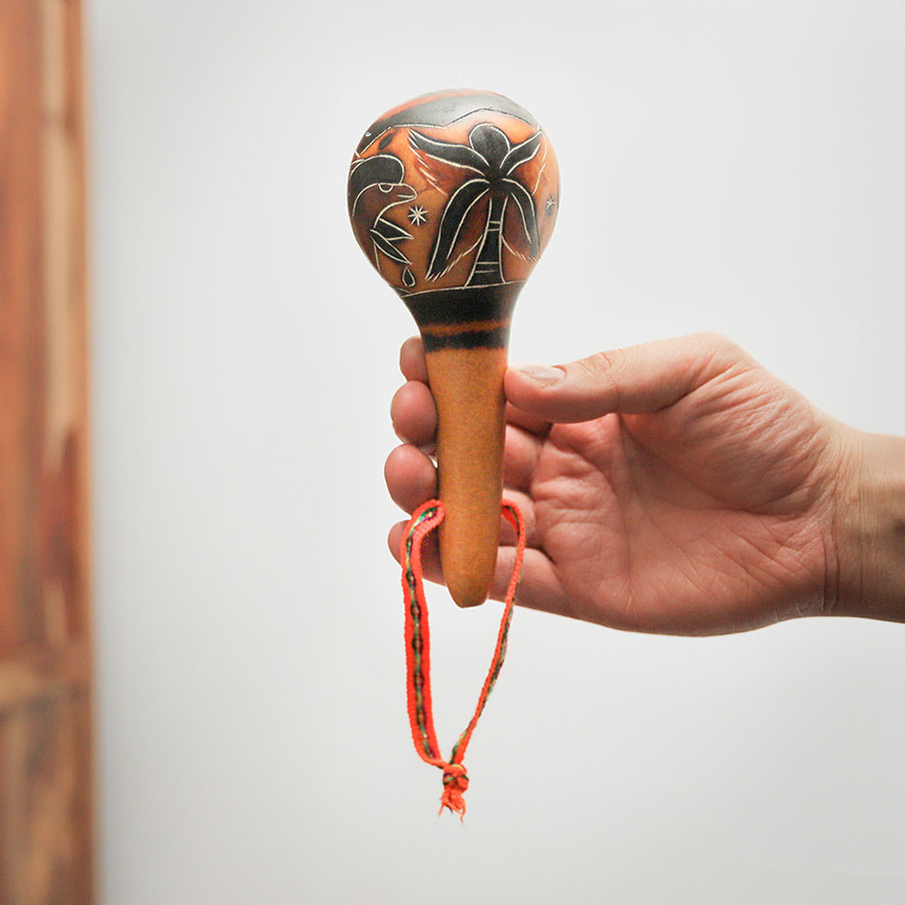 Handmade Tarma Gourd Shaker from Peru, crafted from natural gourds with intricate native art. Produces warm, resonant tones, ideal for musicians and collectors.
