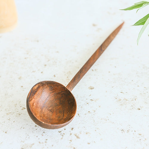 walnut wood serving spoon with deep scooping end 
