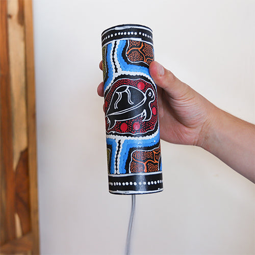 dot painted thunder drum in hand